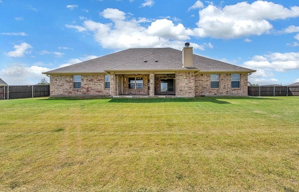 279 Sportsman Drive, Lorena, TX 76655 Expansive backyard featuring a manicured lawn, brick exterior, and covered patio
