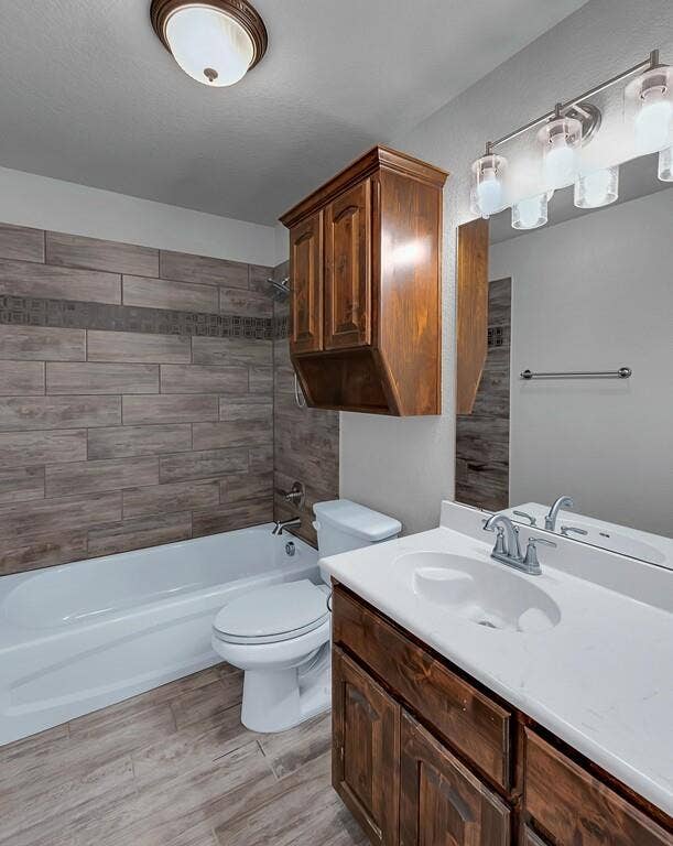 279 Sportsman Drive, Lorena, TX 76655 Wood-look tile flooring, wood-finish vanity with an integrated sink, and an overhead lighting fixture