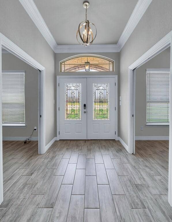 279 Sportsman Drive, Lorena, TX 76655 Double front entry doors with decorative glass inserts, an arched transom window, wood-finish flooring, and a contemporary ceiling light fixture