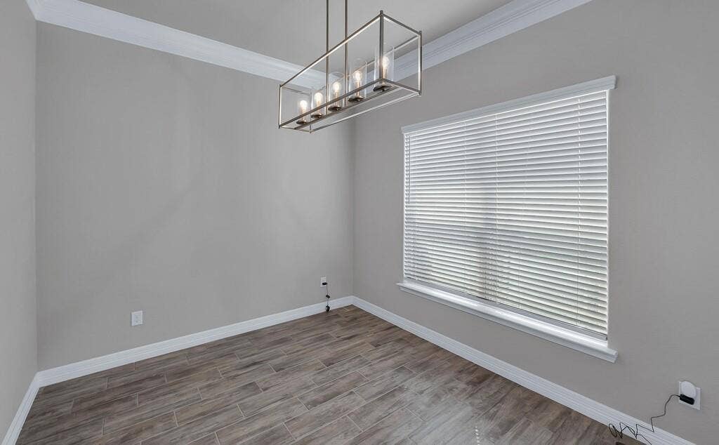 279 Sportsman Drive, Lorena, TX 76655 Wood-finish flooring, crown molding, white baseboards, and a modern rectangular chandelier