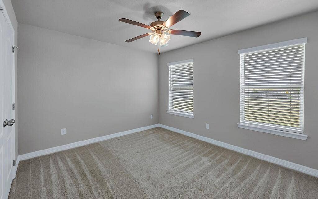 279 Sportsman Drive, Lorena, TX 76655 Neutral-toned walls, two windows with blinds, ceiling fan with integrated lighting, and carpeted flooring