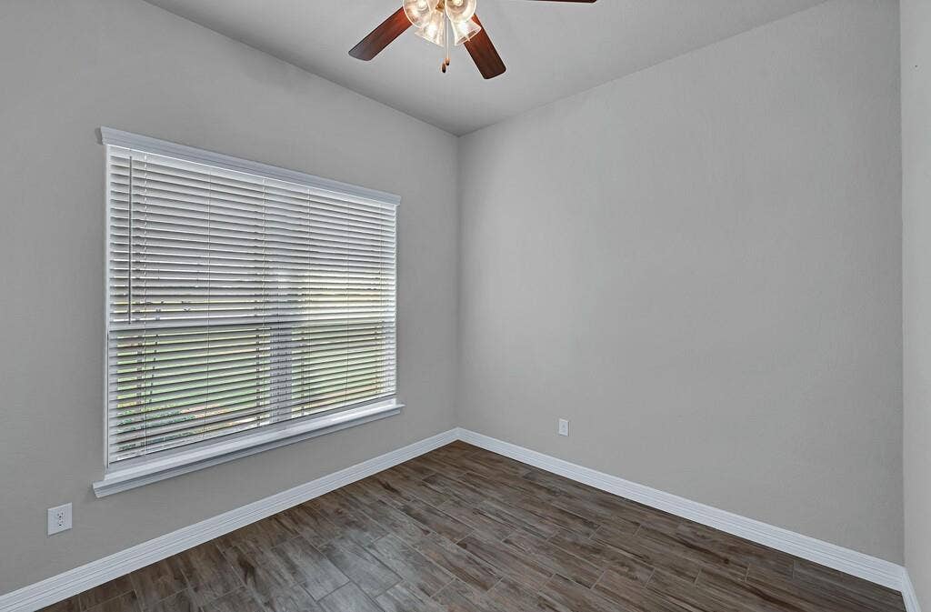 279 Sportsman Drive, Lorena, TX 76655 Neutral wall color, wood-finish flooring, ceiling fan with light fixture, window with horizontal blinds, white trim