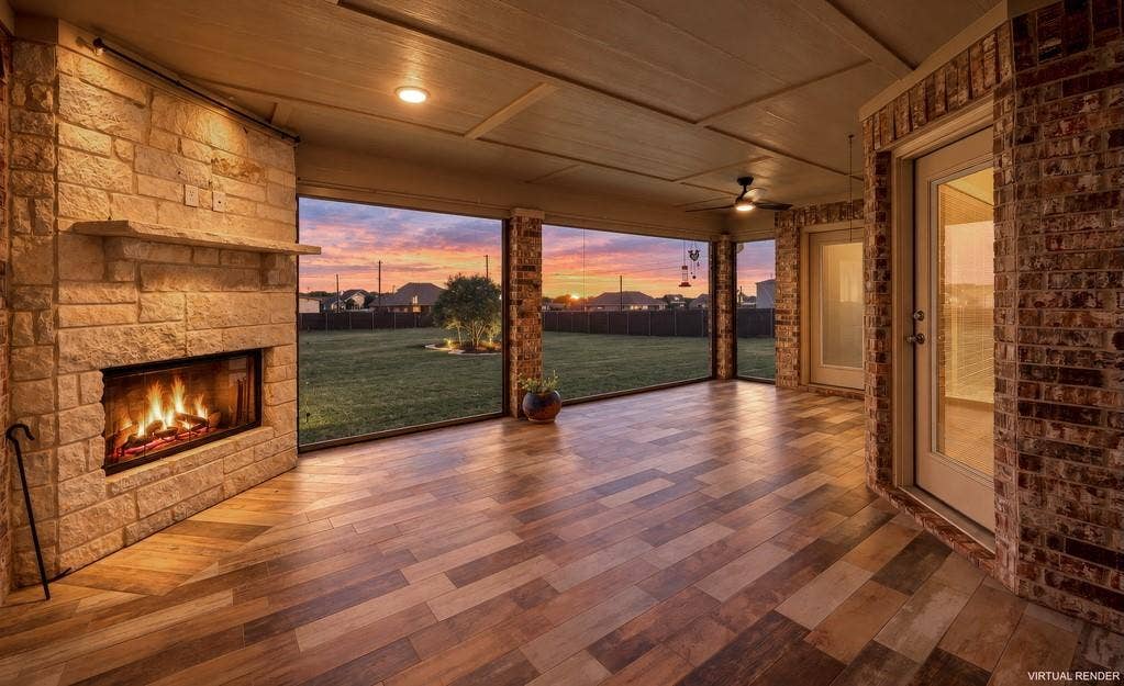 279 Sportsman Drive, Lorena, TX 76655 Expansive covered patio featuring a stone-clad fireplace, wood-finish flooring, brick exterior walls, and recessed lighting, Remote Solar Screens