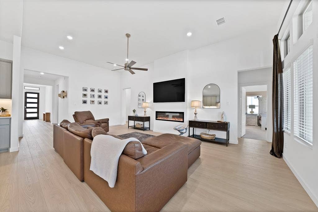 3701 Turpin Drive, Princeton, TX 75071 Very spacious inviting family room with an electric fireplace and a wall of windows.