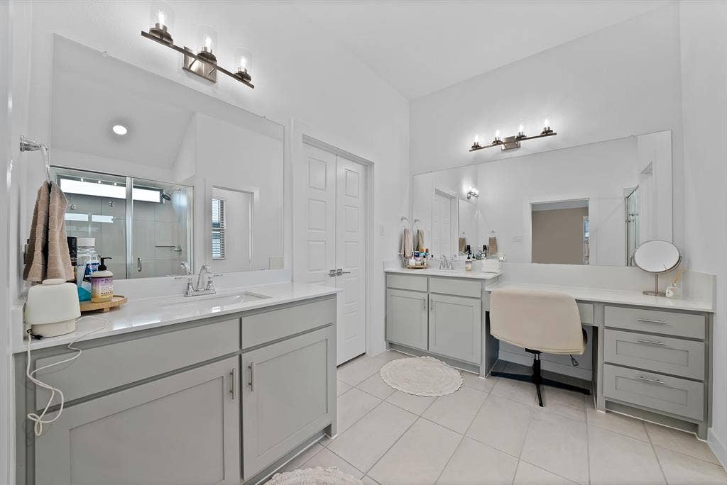 3701 Turpin Drive, Princeton, TX 75071 Dual vanities with undermount sinks, integrated vanity counter, light gray cabinetry, and tile flooring.
