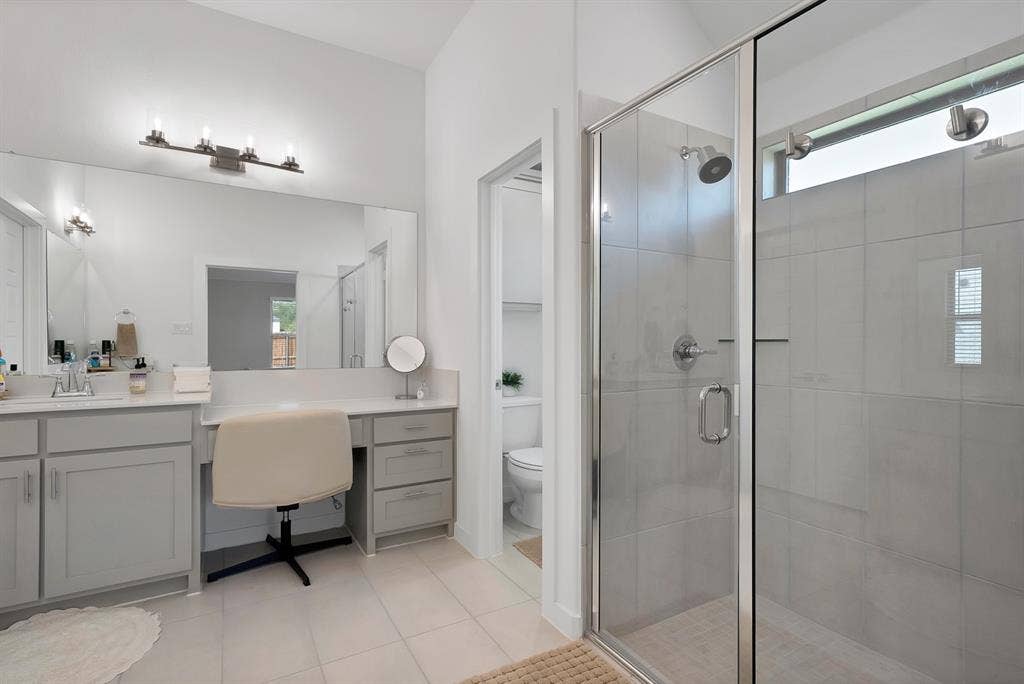 3701 Turpin Drive, Princeton, TX 75071 Glass-enclosed shower with tile surround and transom window.
