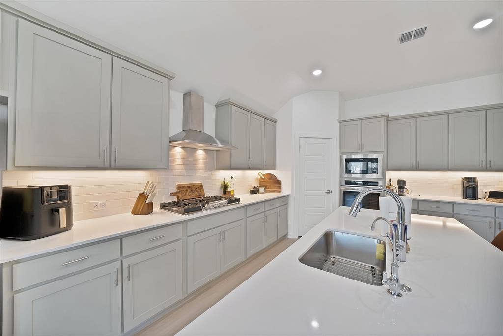 3701 Turpin Drive, Princeton, TX 75071 Stainless steel appliances with a beautiful backsplash keeping this kitchen sleek.