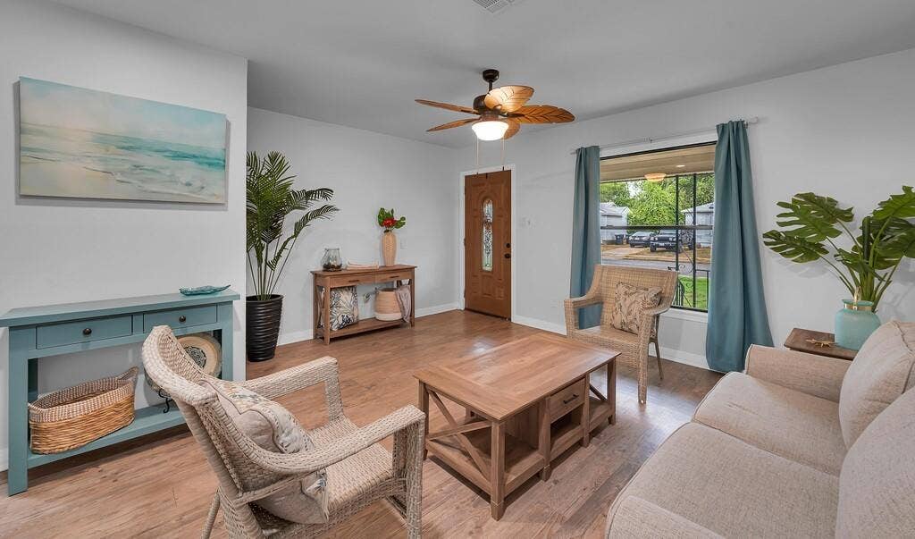 3720 Trice Avenue, Waco, TX 76707 Wood-finish flooring, ceiling fan with integrated lighting, and a front entry door with decorative glass inserts