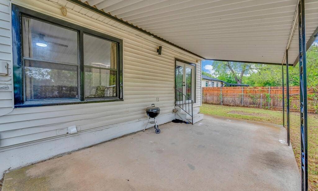 3720 Trice Avenue, Waco, TX 76707 Expansive covered patio with a concrete surface, providing direct access to the interior through a glass-paneled door