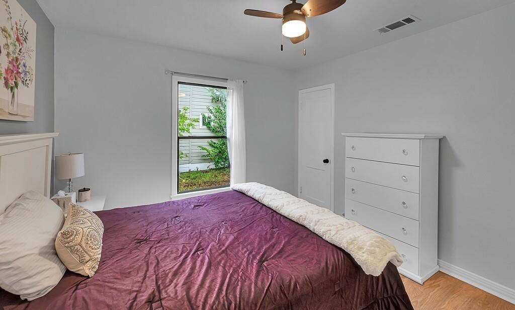 3720 Trice Avenue, Waco, TX 76707 Wood-finish flooring, ceiling fan with integrated lighting, white paneled door, and a single window