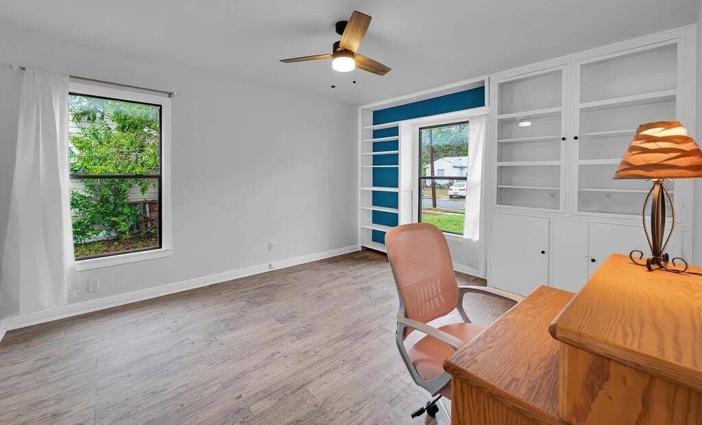 3720 Trice Avenue, Waco, TX 76707 Wood-finish flooring, ceiling fan, built-in shelving, white trim, and light-colored walls