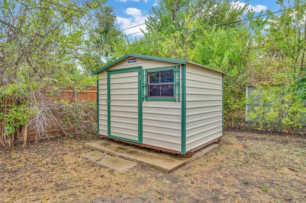 3720 Trice Avenue, Waco, TX 76707 Metal storage shed with a panel door, a single-pane window, and a green trim
