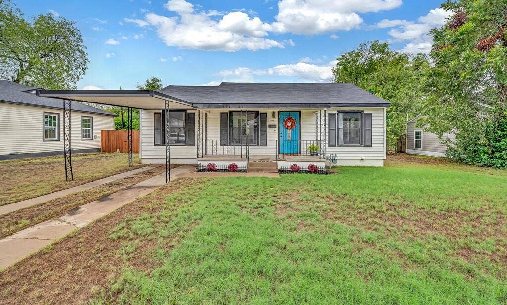 3720 Trice Avenue, Waco, TX 76707 White siding exterior with black window shutters and a blue front door