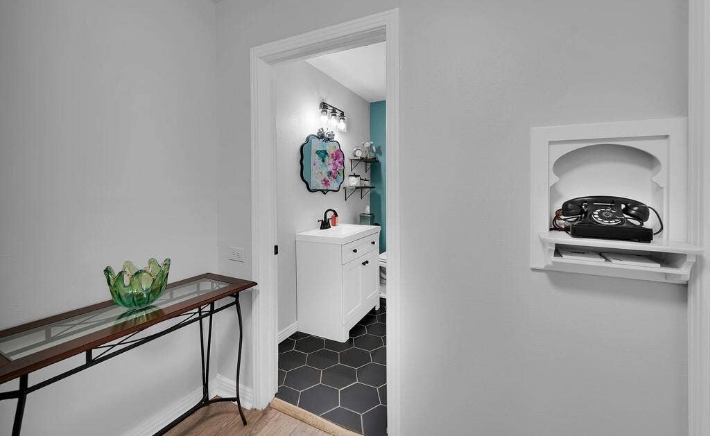 3720 Trice Avenue, Waco, TX 76707 Recessed wall niche, hexagon floor tiling, single vanity, wall-mounted light fixture, white trim