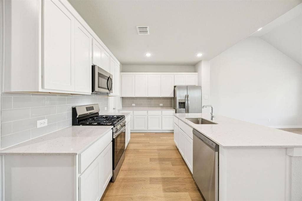 Kitchen in the Masters home plan by Trophy Signature Homes – REPRESENTATIVE PHOTO