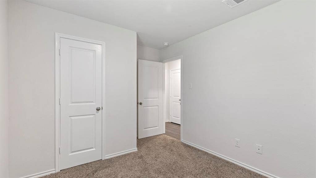 1117 Overhill Road, Josephine, TX 75135 Neutral tone wall paint, paneled interior doors, and carpet flooring