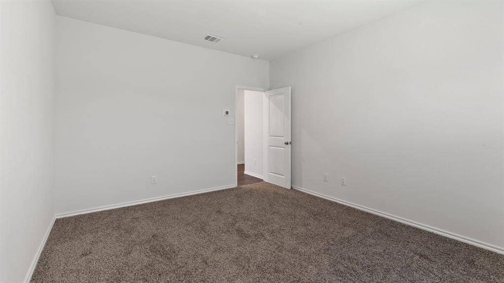 1117 Overhill Road, Josephine, TX 75135 Neutral wall paint, carpet flooring, and a paneled interior door