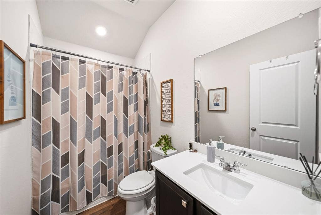 Vanity with an integrated rectangular sink, chrome faucet, and dark wood-finish cabinetry