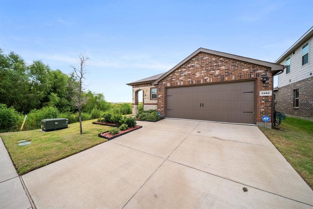 Brick and stone exterior with a two-car garage