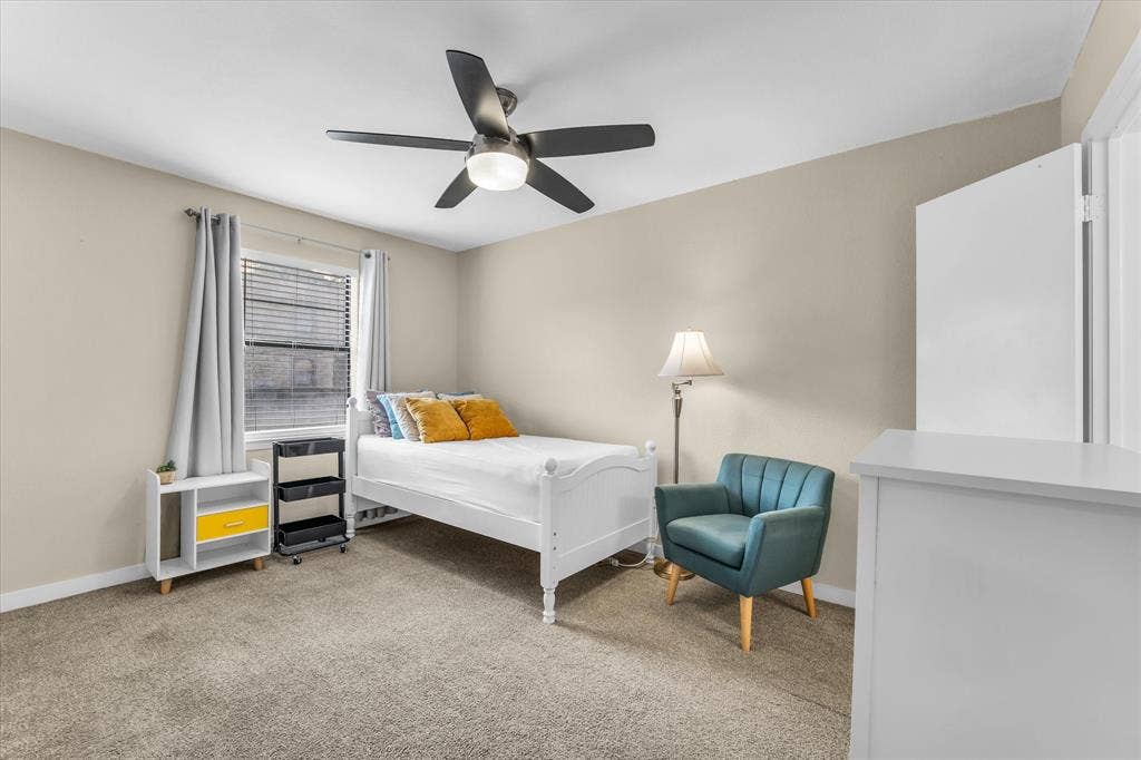 1214 Baylor Avenue, #109, Waco, TX 76706 Carpeted room featuring a ceiling fan with integrated lighting, a window with blinds, and neutral-toned walls