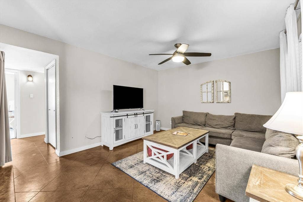 1214 Baylor Avenue, #109, Waco, TX 76706 Spacious living area featuring tile flooring, a ceiling fan with integrated lighting, and neutral wall tones