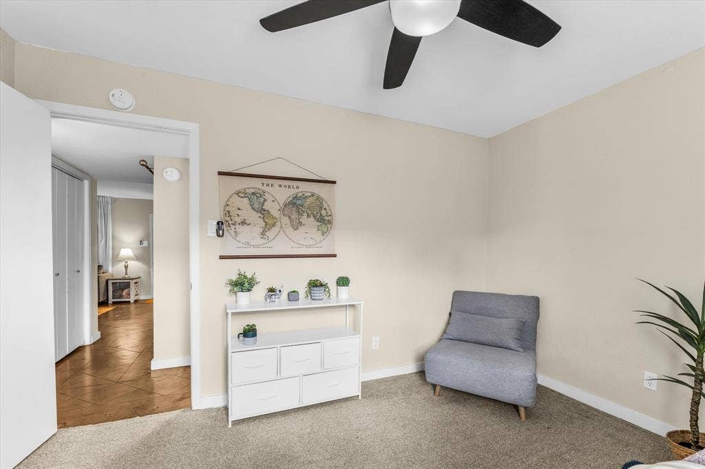 1214 Baylor Avenue, #109, Waco, TX 76706 Carpeted room with a ceiling fan, light-toned walls, and white trim