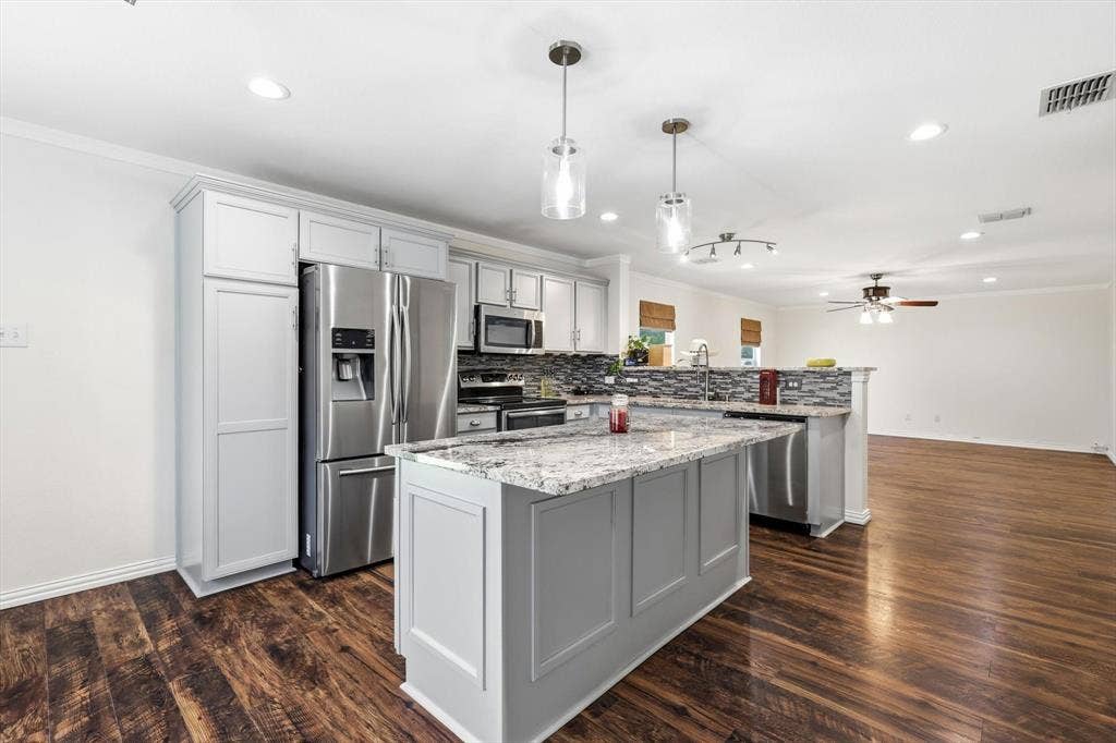 800 Poncho Lane, Fort Worth, TX 76052 Kitchen featuring light gray cabinetry, stainless steel appliances, a center island with a stone countertop, and wood-finish flooring