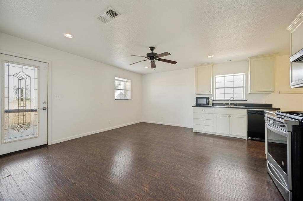 8400 Holder Road, Northlake, TX 76247 Wood-finish flooring, recessed lighting, ceiling fan, white cabinetry with dark countertops, and stainless steel appliances