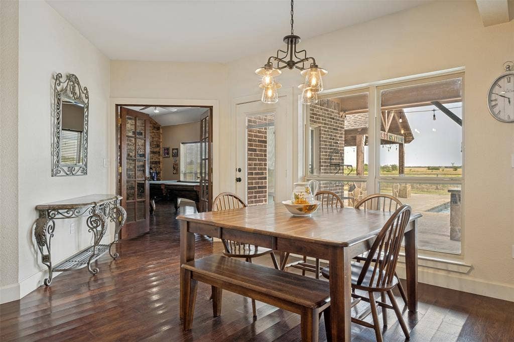 8400 Holder Road, Northlake, TX 76247 Wood-finish flooring, multi-pane windows, and a black iron chandelier with glass shades