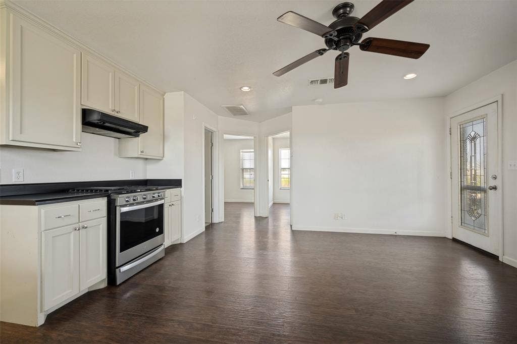 8400 Holder Road, Northlake, TX 76247 Kitchen with light cabinetry, dark countertops, and stainless steel range