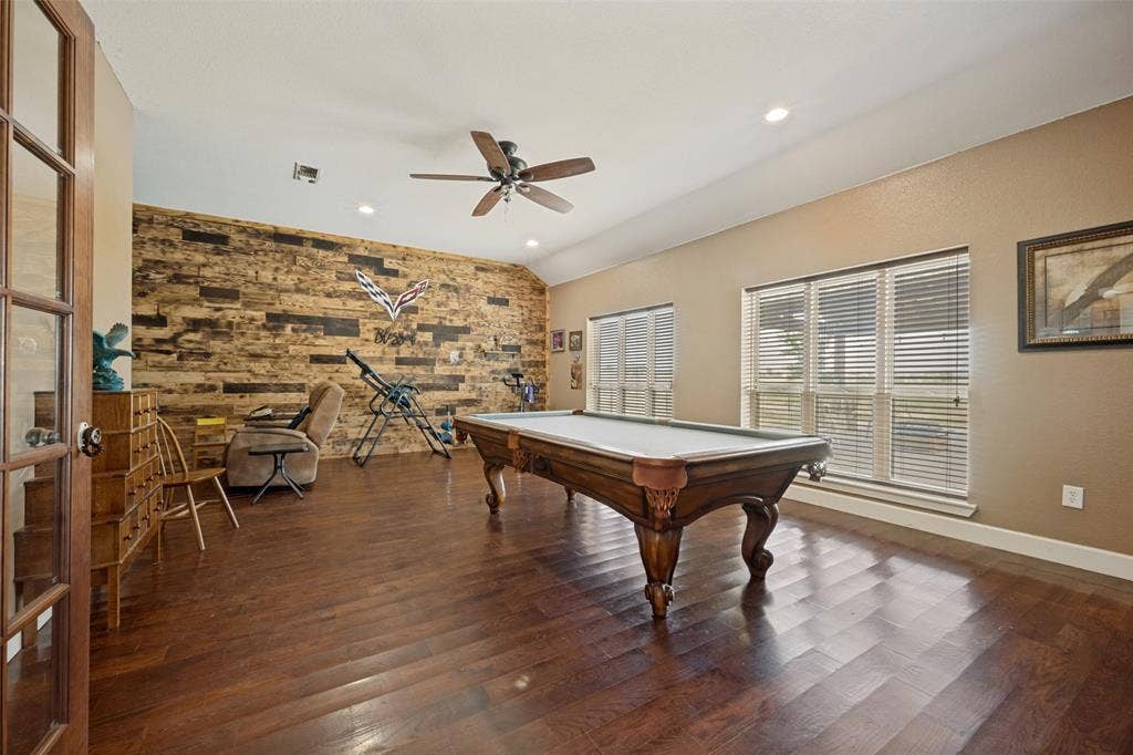 8400 Holder Road, Northlake, TX 76247 Family room with wood flooring, wood-paneled accent wall, recessed lighting, ceiling fan, and French doors