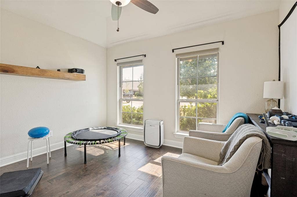 4601 Massey Meadows Way, Midlothian, TX 76065 Spacious office featuring wood-finish flooring, a ceiling fan, and two windows providing natural illumination