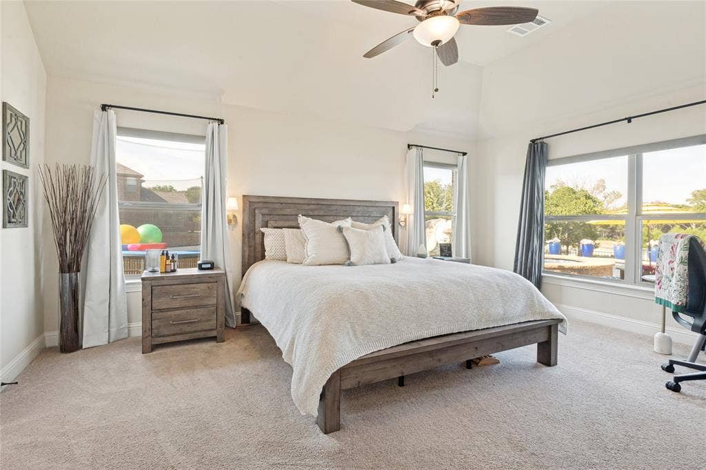 4601 Massey Meadows Way, Midlothian, TX 76065 Vaulted ceilings with a ceiling fan, carpeted flooring, and multiple windows