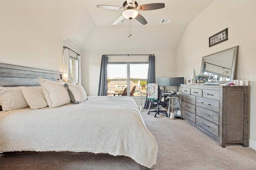4601 Massey Meadows Way, Midlothian, TX 76065 Vaulted ceiling with a ceiling fan, plush carpet flooring, and abundant natural light from multiple windows