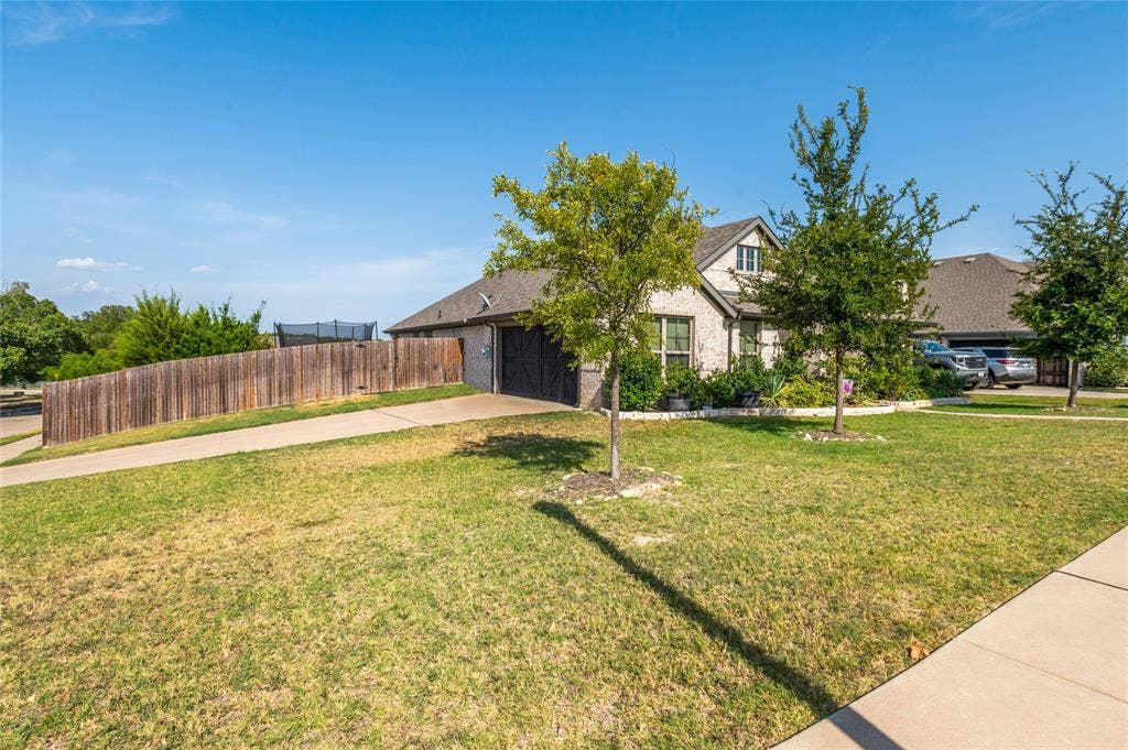 4601 Massey Meadows Way, Midlothian, TX 76065 Brick exterior with a dark roof and an attached garage