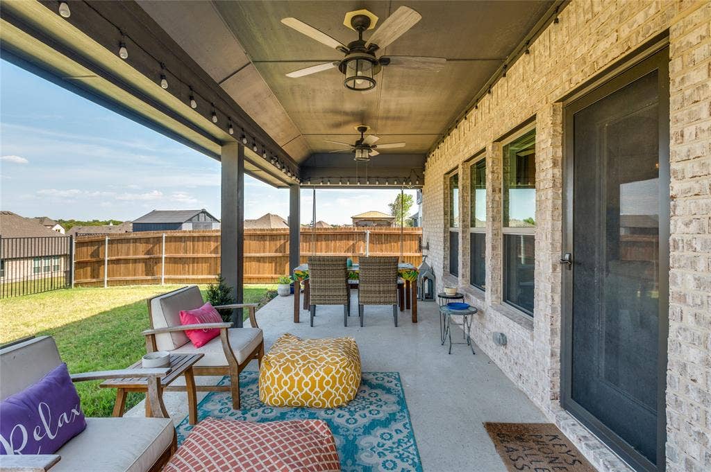 4601 Massey Meadows Way, Midlothian, TX 76065 Covered patio featuring two ceiling fans, recessed string lighting, a concrete floor, and light brick exterior
