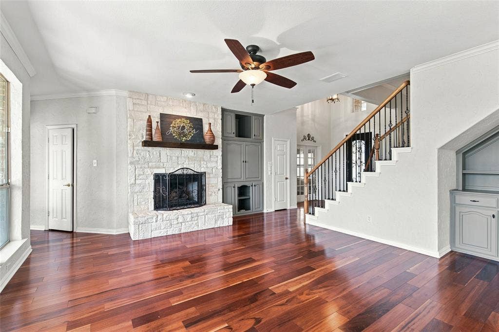 1820 Forest Bend Lane, Keller, TX 76248 Stone fireplace with wood mantel and built-in cabinetry in living room.