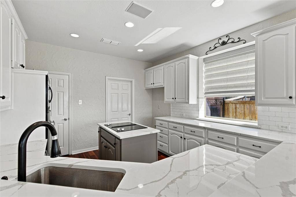 1820 Forest Bend Lane, Keller, TX 76248 Kitchen featuring white cabinetry, quartz countertops, and a stainless steel sink with a matte black faucet.