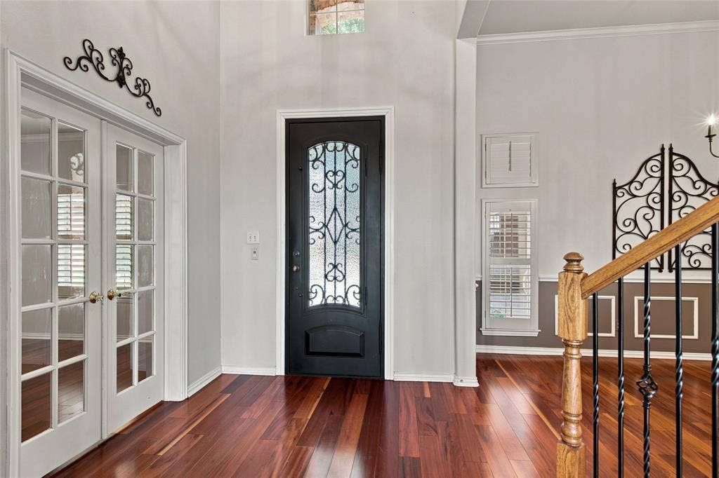 1820 Forest Bend Lane, Keller, TX 76248 Hardwood flooring, decorative glass entry door, French doors with glass panes, dining room and wooden staircase with iron balusters