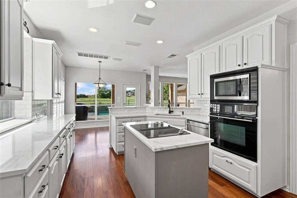 1820 Forest Bend Lane, Keller, TX 76248 View from laundry and garage entry of kitchen with integrated stainless steel appliances.