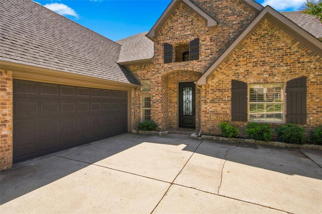 1820 Forest Bend Lane, Keller, TX 76248 Front Entry with arched entryway and a decorative glass and metal front door.