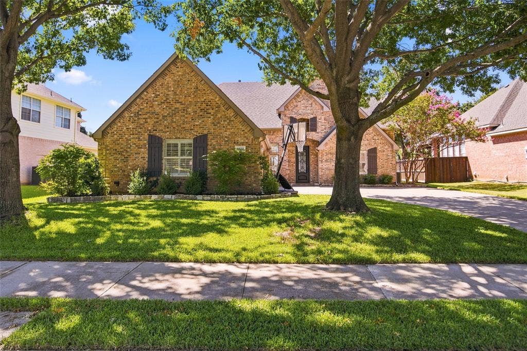 1820 Forest Bend Lane, Keller, TX 76248 Brick exterior with contrasting dark window shutters, gabled roofline, mature trees, and a lush lawn