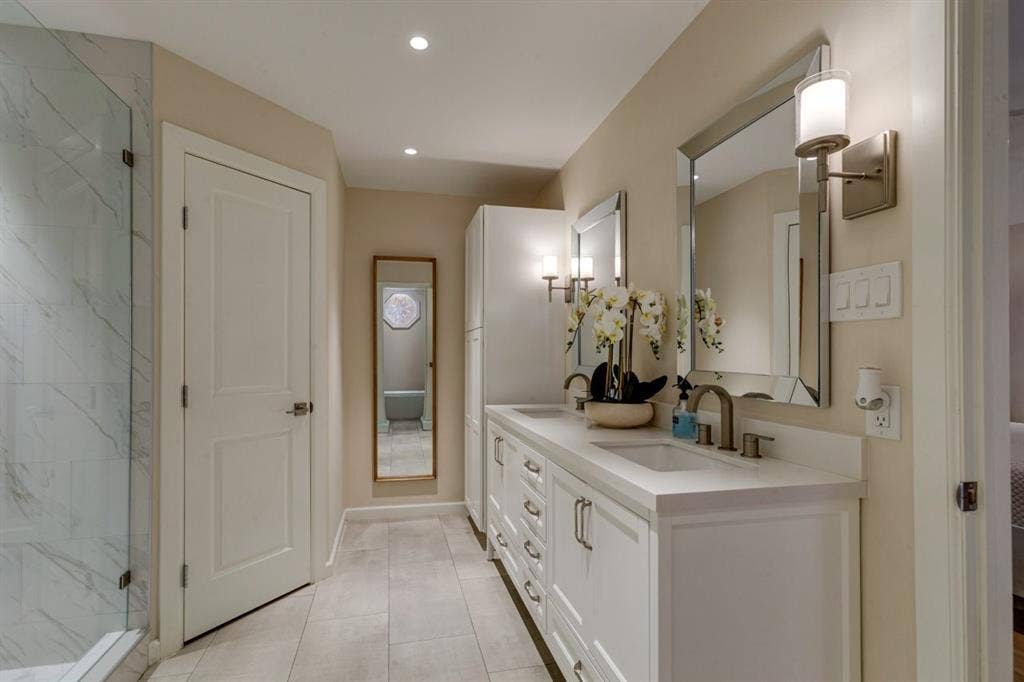 1408 Quapaw Trail, Mesquite, TX 75149 Dual vanity with integrated sinks, white cabinetry, and brushed nickel hardware