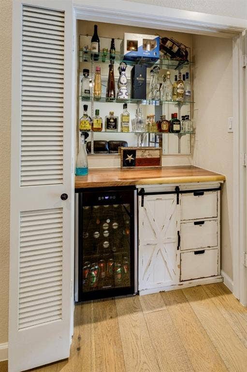 1408 Quapaw Trail, Mesquite, TX 75149 Built-in wet bar featuring glass shelving, wood-finish countertop, and integrated beverage cooler