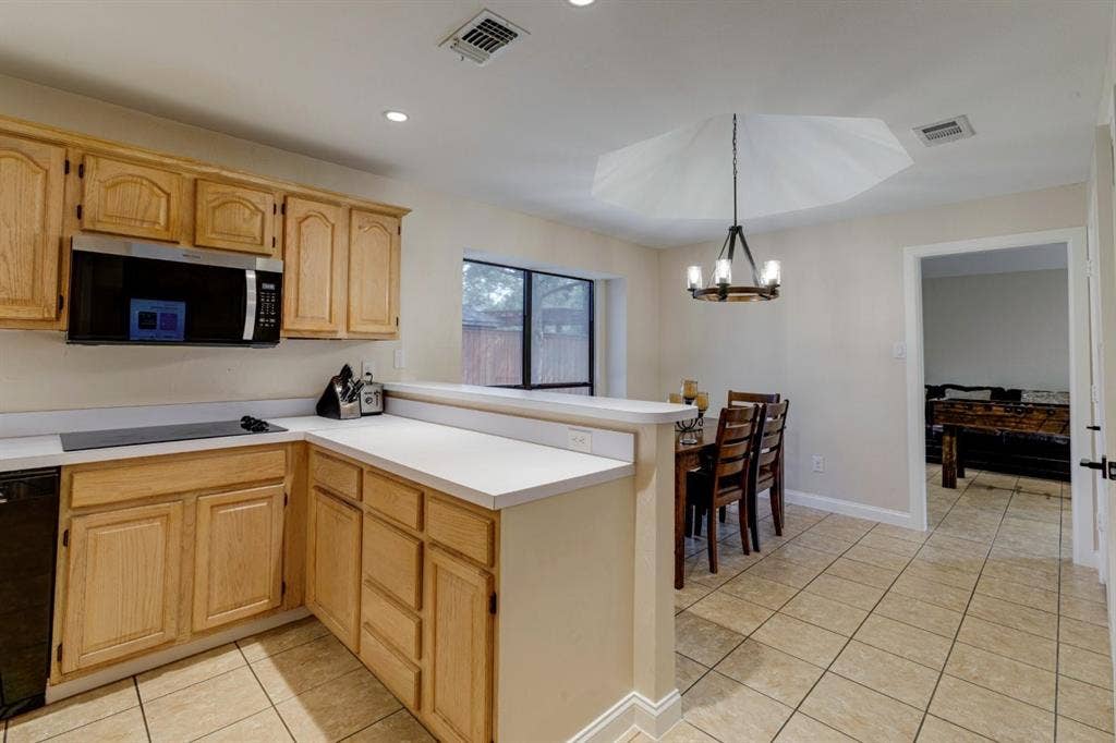 1408 Quapaw Trail, Mesquite, TX 75149 Kitchen featuring wood cabinetry, white countertops, built-in microwave, tile flooring, and recessed lighting