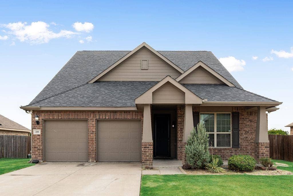 259 Saddlebrook Lane, Waxahachie, TX 75165 Brick and siding exterior with a gabled roofline and multiple roof peaks