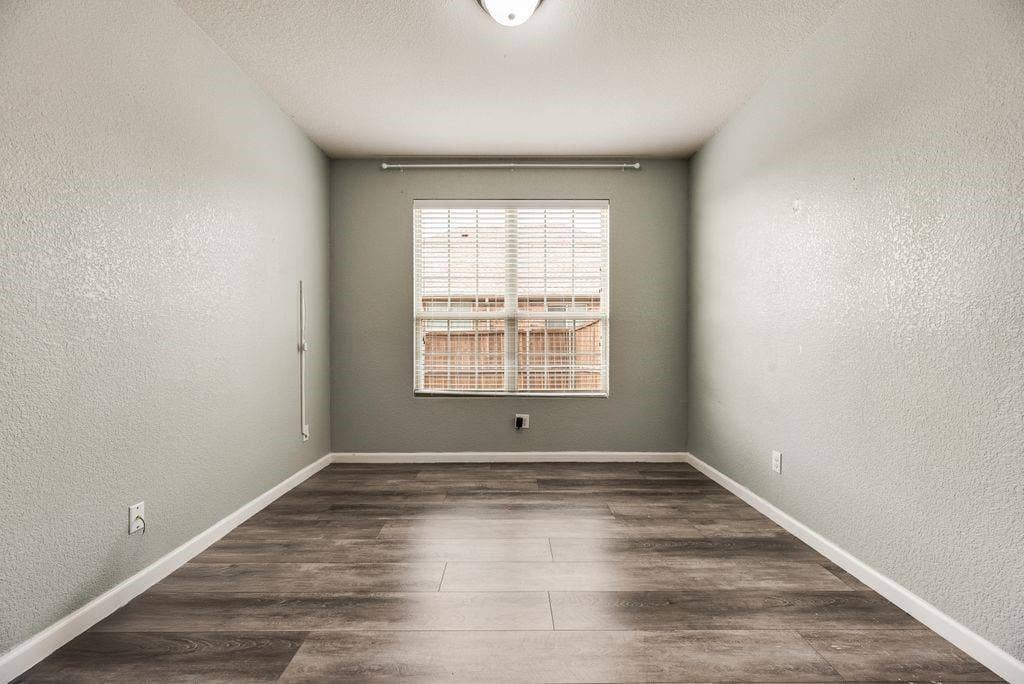 259 Saddlebrook Lane, Waxahachie, TX 75165 Wood-finish flooring, textured walls, window with horizontal blinds, and a flush mount ceiling light fixture