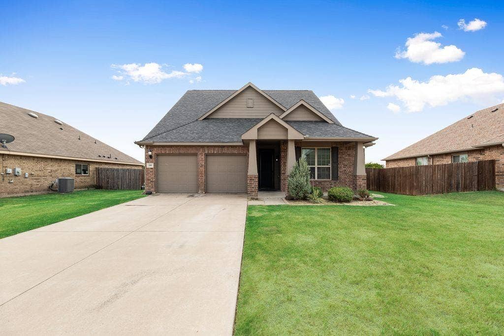 259 Saddlebrook Lane, Waxahachie, TX 75165 Brick exterior with architectural gable detailing and professional landscaping