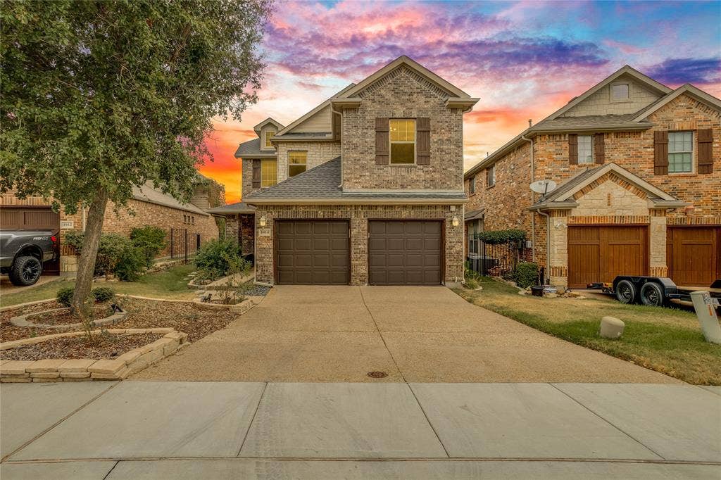 1014 Kaylie Street, Grand Prairie, TX 75052 Brick and stone facade with a two-car garage