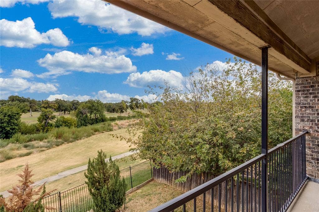 1014 Kaylie Street, Grand Prairie, TX 75052 Balcony with brick exterior, wrought iron railing, and a cement patio